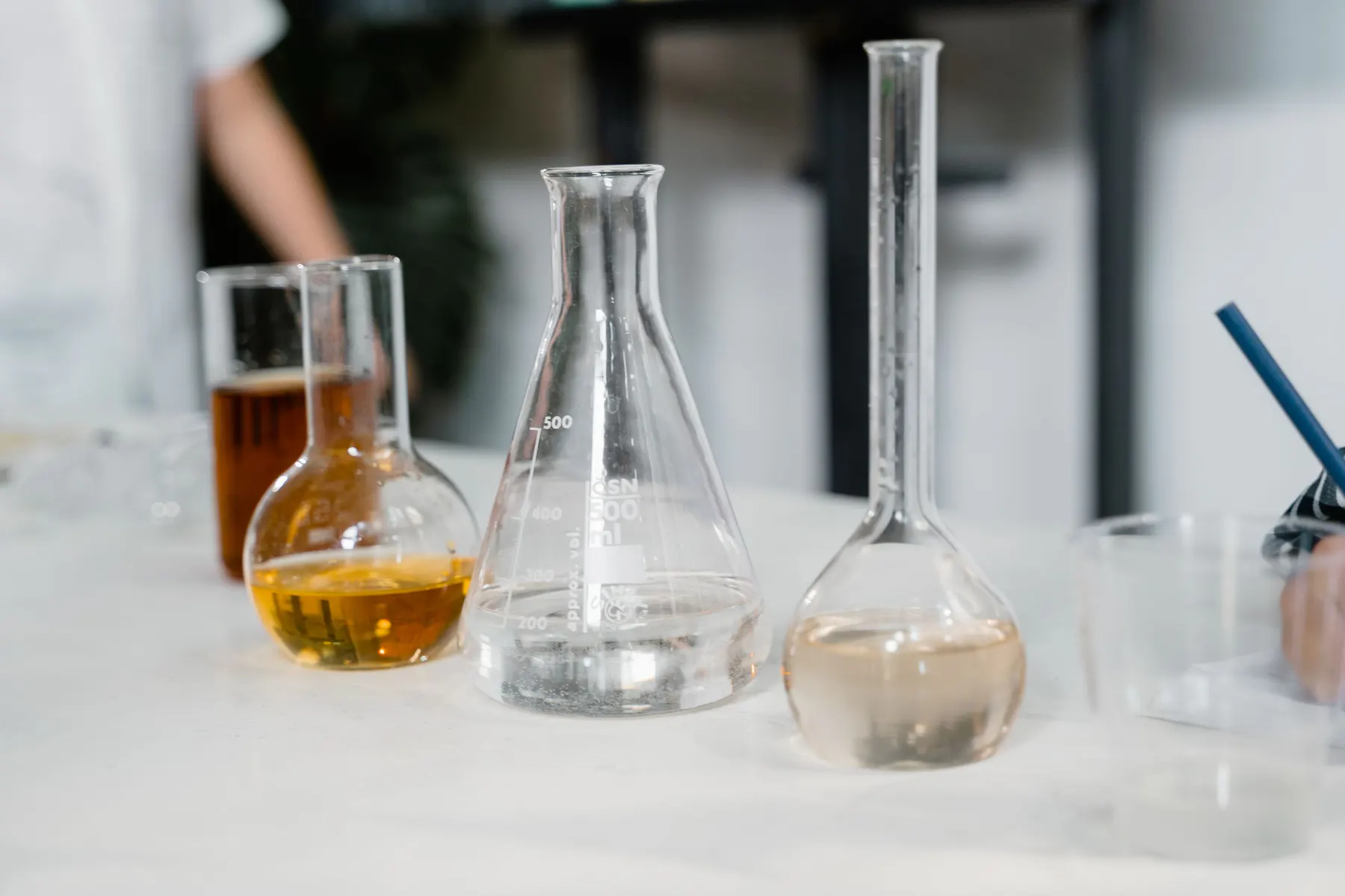 Clear laboratory vessels holding liquid formulation samples