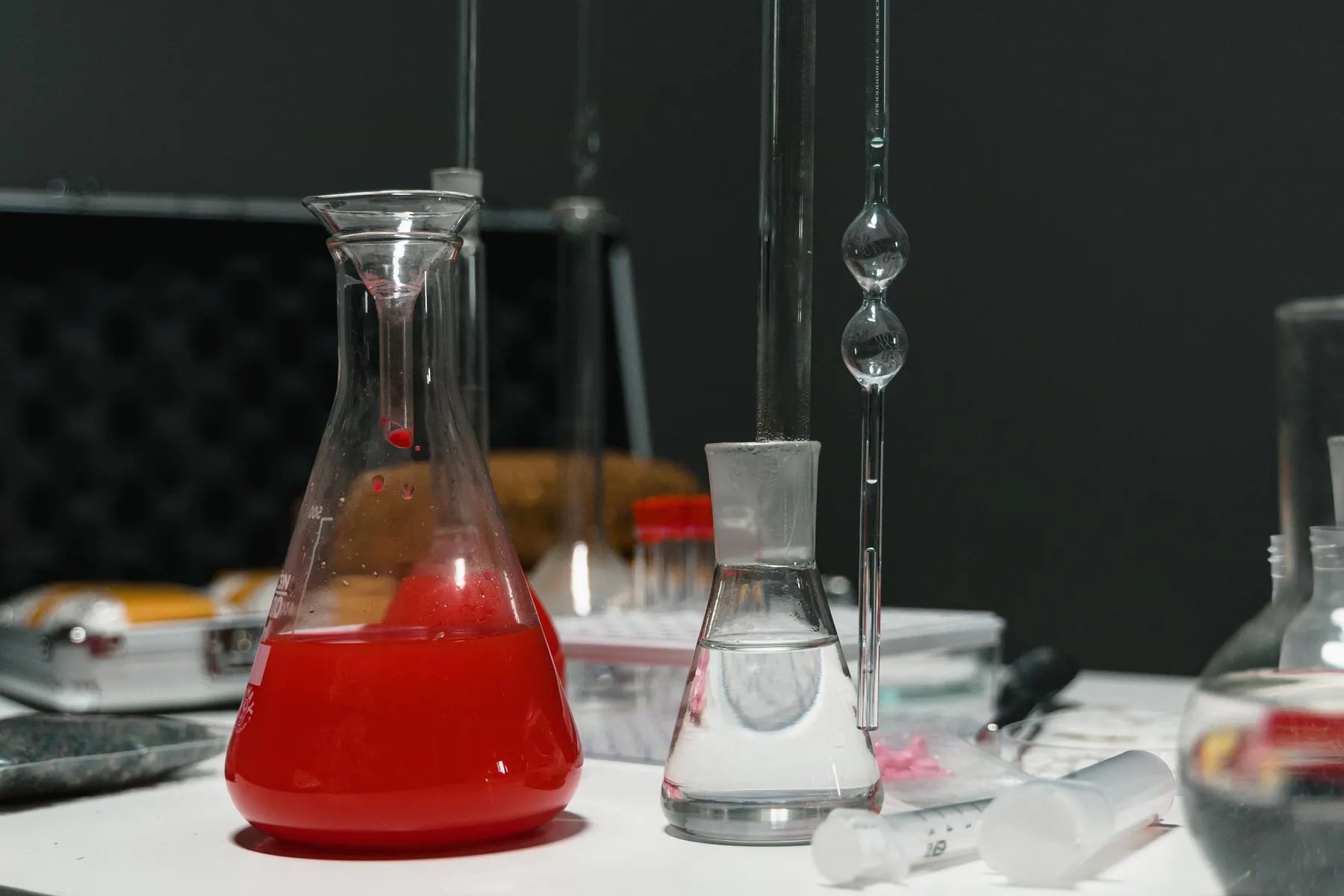 Laboratory glassware containing measured formulation liquids