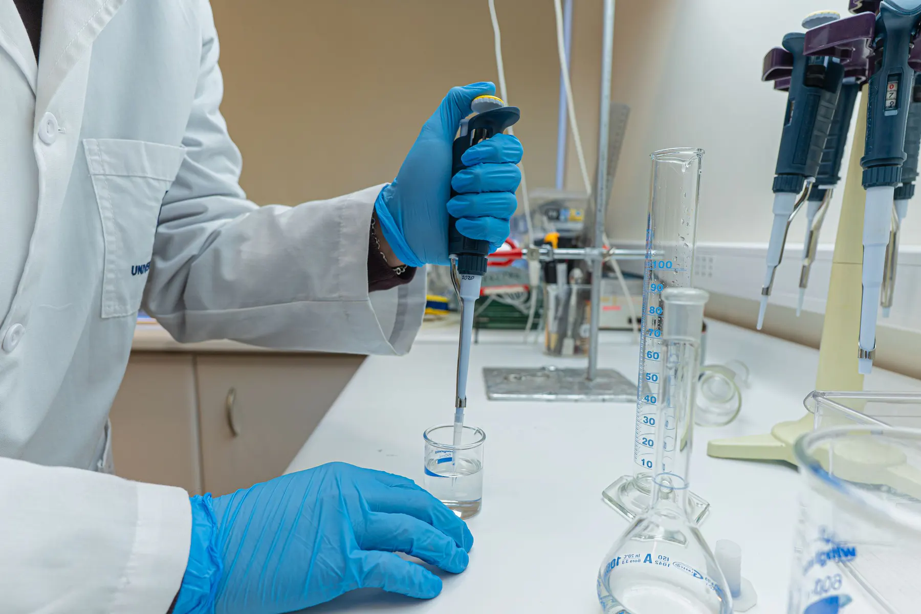 Laboratory scientist carrying out a precision pipette procedure